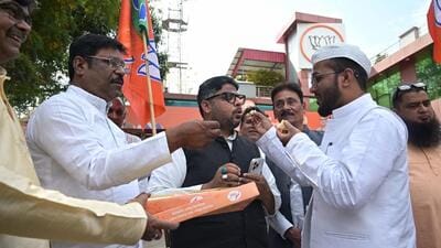 Uttar Pradesh BJP Minority Morcha leader Kunwar Basit Ali distributing sweets at the BJP office in Lucknow on Wednesday. (Mustaq Khan/HT) Uttar Pradesh BJP Minority Morcha leader Kunwar Basit Ali distributing sweets at the BJP office in Lucknow on Wednesday. (Mustaq Khan/HT)