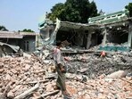A man stands on the ruins of a hotel where survivor Tin Maung Htwe was extracted in Sagaing on April 3, 2025, following the March 28 earthquake. A man stands on the ruins of a hotel where survivor Tin Maung Htwe was extracted in Sagaing on April 3, 2025, following the March 28 earthquake.