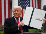 US President Donald Trump holds a signed executive order on tariffs, in the Rose Garden at the White House in Washington DC, US, on April 2, 2025.