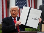 US President Donald Trump holds a signed executive order on tariffs, in the Rose Garden at the White House in Washington DC, US, on April 2, 2025.