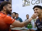 Virat Kohli (L) and Swastik Chikara Virat Kohli (L) and Swastik Chikara