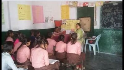 A teacher busy teaching kids in a government-run primary school in Prayagraj. (File) A teacher busy teaching kids in a government-run primary school in Prayagraj. (File)