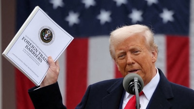 US President Donald Trump holds a "Foreign Trade Barriers" document as he delivers remarks on tariffs in the Rose Garden at the White House in Washington DC on April 2, 2025. (Reuters)