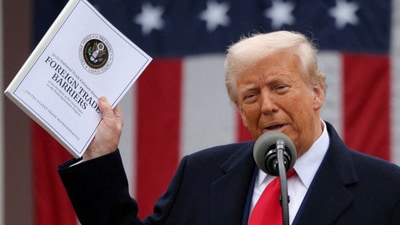 US President Donald Trump holds a "Foreign Trade Barriers" document as he delivers remarks on tariffs in the Rose Garden at the White House in Washington DC on April 2, 2025. (Reuters)