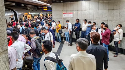 Commuters wait in a queue to board the Blue Line of the Delhi Metro, in New Delhi. (PTI) (Representational) Commuters wait in a queue to board the Blue Line of the Delhi Metro, in New Delhi. (PTI) (Representational)