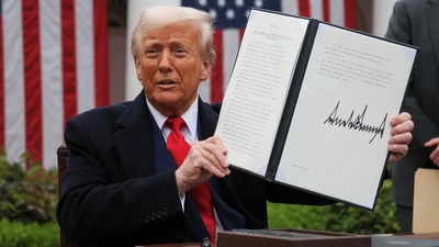 US President Donald Trump holds a signed executive order on tariffs, in the Rose Garden at the White House in Washington DC, US, on April 2, 2025. (Reuters)