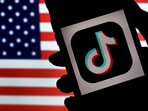 (FILES) In this photo illustration, the social media application logo, TikTok is displayed on the screen of an iPhone on an American flag background on August 3, 2020 in Arlington, Virginia. (FILES) In this photo illustration, the social media application logo, TikTok is displayed on the screen of an iPhone on an American flag background on August 3, 2020 in Arlington, Virginia.