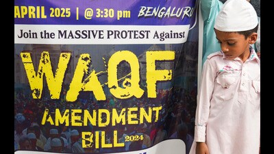**EDS: RPT, CORRECTS GRAMMAR IN CAPTION** Bengaluru: A boy stands near a poster during a protest against the passage of the Waqf (Amendment) Bill in the Parliament, in Bengaluru, Friday, April 4, 2025. (PTI Photo/Shailendra Bhojak) (PTI04_04_2025_RPT266A) (PTI) **EDS: RPT, CORRECTS GRAMMAR IN CAPTION** Bengaluru: A boy stands near a poster during a protest against the passage of the Waqf (Amendment) Bill in the Parliament, in Bengaluru, Friday, April 4, 2025. (PTI Photo/Shailendra Bhojak) (PTI04_04_2025_RPT266A) (PTI)