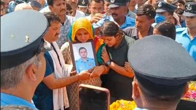 The parents and younger sister of flight lieutenant Siddharth Yadav holding his photo at his cremation in their native village of Majra Bhalkhi in Rewari district of Haryana on Friday. (HT Photo) The parents and younger sister of flight lieutenant Siddharth Yadav holding his photo at his cremation in their native village of Majra Bhalkhi in Rewari district of Haryana on Friday. (HT Photo)