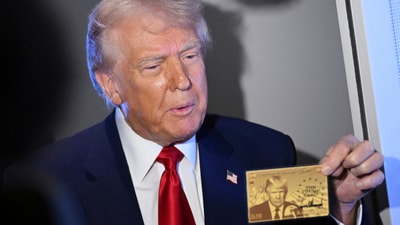 President Donald Trump holds up the $5 million gold card as he speaks to reporters while in flight on board Air Force One, en route to Miami, Thursday, April 3, 2025. (Pool via AP) (AP)