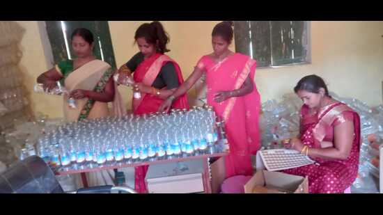 SHG women busy packaging Sangam water for dispatch in Jasra, Prayagraj (HT Photo)
