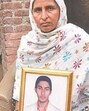 The mother of the victim with her son’s picture (Sourced) The mother of the victim with her son’s picture (Sourced)
