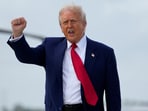 US President Donald Trump gestures as he disembarks Air Force One.