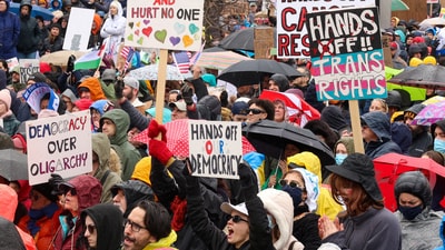 People take part in the nationwide "Hands Off" anti-Trump protests in Boston, (REUTERS)