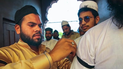 A Muslim devotee ties a black armband on another devotee as they arrive to offer 'namaz' on the last Friday of the holy month of Ramzan, at Taj-ul-Masajid, in Bhopal, Friday, March 28, 2025. (PTI FILE) A Muslim devotee ties a black armband on another devotee as they arrive to offer 'namaz' on the last Friday of the holy month of Ramzan, at Taj-ul-Masajid, in Bhopal, Friday, March 28, 2025. (PTI FILE)