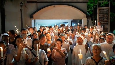 Catholic nuns joins others as they hold candles while offering prayers for the country and also victims of the recent earthquake in Myanmar after a religious procession in observance of lent, in Quezon city, Philippines Friday, April 4, 2025. (AP)