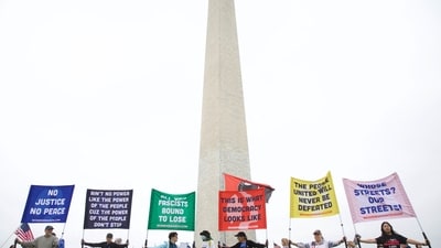 Demonstrators gather on the National Mall for the nationwide "Hands Off!" protest against US President Donald Trump and his advisor, Tesla CEO Elon Musk, in Washington, DC, on April 5, 2025. (Photo by Amid FARAHI / AFP) (AFP) Demonstrators gather on the National Mall for the nationwide "Hands Off!" protest against US President Donald Trump and his advisor, Tesla CEO Elon Musk, in Washington, DC, on April 5, 2025. (Photo by Amid FARAHI / AFP) (AFP)
