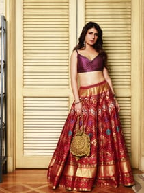 Outfit: WeaverStory, Bag: 3.10 by Guggi | Turning heads in a rich Banarasi Patola lehenga by WeaverStory, the actor adds whimsy with a playful peacock crochet bag from 3.10 by Guggi. Pastel-toned earrings by ASV Polkis subtly balance the boldness with grace. (Photo: Sarang Gupta)
