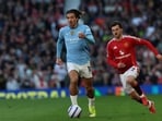 Manchester City's English midfielder #10 Jack Grealish runs away from Manchester United's English midfielder #07 Mason Mount