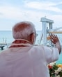 Prime Minister Narendra Modi waves to the Indian Coast Guard ship during the inauguration of New Pamban Bridge, at Rameswaram in Ramanathapuram on Sunday. (DPR PMO) Prime Minister Narendra Modi waves to the Indian Coast Guard ship during the inauguration of New Pamban Bridge, at Rameswaram in Ramanathapuram on Sunday. (DPR PMO)