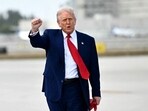 US President Donald Trump pumps his fist upon arrival at Miami International Airport. US President Donald Trump pumps his fist upon arrival at Miami International Airport.