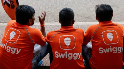 Swiggy gig workers talk to each other during a promotional event in Mumbai, India, October 14, 2024. (REUTERS FILE)