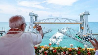 Prime Minister Narendra Modi waves to the Indian Coast Guard ship during the inauguration of New Pamban Bridge, at Rameswaram in Ramanathapuram on Sunday. (DPR PMO) Prime Minister Narendra Modi waves to the Indian Coast Guard ship during the inauguration of New Pamban Bridge, at Rameswaram in Ramanathapuram on Sunday. (DPR PMO)