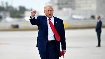 US President Donald Trump pumps his fist upon arrival at Miami International Airport. (AFP) US President Donald Trump pumps his fist upon arrival at Miami International Airport. (AFP)