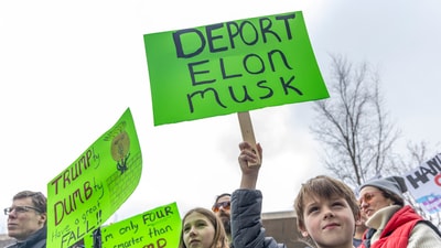 Eight-year-old Teddy Burdick listens to speakers alongside his sister, 11-year-old Addy Burdick, during a Hands Off! rally on Saturday, April 5, 2025 at Rosa Parks Circle in Grand Rapids, Mich. (AP) Eight-year-old Teddy Burdick listens to speakers alongside his sister, 11-year-old Addy Burdick, during a Hands Off! rally on Saturday, April 5, 2025 at Rosa Parks Circle in Grand Rapids, Mich. (AP)