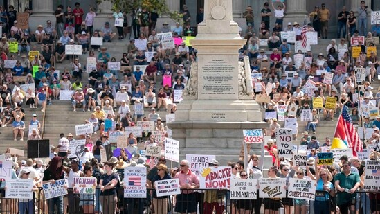 Demonstrators participate in a Hands Off protest at the statehouse on April 5, 2025 in Columbia, South Carolina. Protests against Trump administration policies and Elon Musk's Department of Government Efficiency (DOGE) are being held nationwide. (Getty Images via AFP)