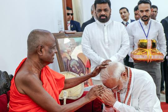 Prime Minister Narendra Modi sought blessings from the head monk at Jaya Sri Maha Bodhi temple in Anuradhapura, as Sri Lankan President Anura Kumara Disanayaka looks on (DPR PMO) Prime Minister Narendra Modi sought blessings from the head monk at Jaya Sri Maha Bodhi temple in Anuradhapura, as Sri Lankan President Anura Kumara Disanayaka looks on (DPR PMO)