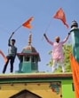Activists of Maharaja Suheldev Samman Suraksha Manch holding saffron coloured flags atop the dargah of Syed Salar Masood Ghazi on Ram Navami in Baharia area of Prayagraj on Sunday. (Sourced) Activists of Maharaja Suheldev Samman Suraksha Manch holding saffron coloured flags atop the dargah of Syed Salar Masood Ghazi on Ram Navami in Baharia area of Prayagraj on Sunday. (Sourced)