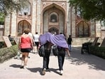Girls drape a scarf as the sun casts its heat at Humayun's tomb in New Delhi last week.
