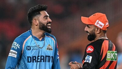 Gujarat Titans' Mohammed Siraj (L) interacts with Sunrisers Hyderabad's Mohammed Shami before the start of the Indian Premier League match. (AFP) Gujarat Titans' Mohammed Siraj (L) interacts with Sunrisers Hyderabad's Mohammed Shami before the start of the Indian Premier League match. (AFP)