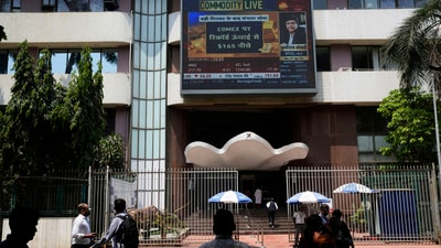 People walk past a live screen on the facade of Bombay Stock Exchange (BSE) building in Mumbai, India, Monday, April 7, 2025. (AP) People walk past a live screen on the facade of Bombay Stock Exchange (BSE) building in Mumbai, India, Monday, April 7, 2025. (AP)