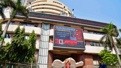Mumbai: People walk past the Bombay Stock Exchange (BSE) building on Monday. (PTI) Mumbai: People walk past the Bombay Stock Exchange (BSE) building on Monday. (PTI)