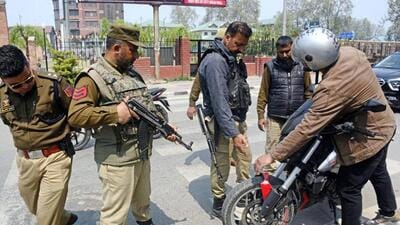 Personnel checking a two-wheeler after security was beefed up across Kashmir Valley in view of Union home minister Amit Shah’s visit in Srinagar on Monday. (PTI Photo) Personnel checking a two-wheeler after security was beefed up across Kashmir Valley in view of Union home minister Amit Shah’s visit in Srinagar on Monday. (PTI Photo)