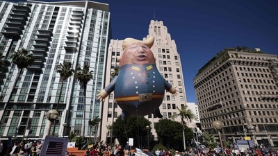 Protesters hold a large balloon with an image of US President Donald Trump during the nationwide "Hands Off!" protest against Trump and his advisor, Tesla CEO Elon Musk, in downtown Los Angeles on April 5, 2025. (AFP) Protesters hold a large balloon with an image of US President Donald Trump during the nationwide "Hands Off!" protest against Trump and his advisor, Tesla CEO Elon Musk, in downtown Los Angeles on April 5, 2025. (AFP)