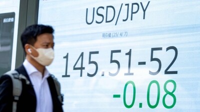 A man looks at an electronic board showing the foreign exchange trading price of the Japanese yen against the US dollar on a street in Tokyo on April 7, 2025. (AFP) A man looks at an electronic board showing the foreign exchange trading price of the Japanese yen against the US dollar on a street in Tokyo on April 7, 2025. (AFP)