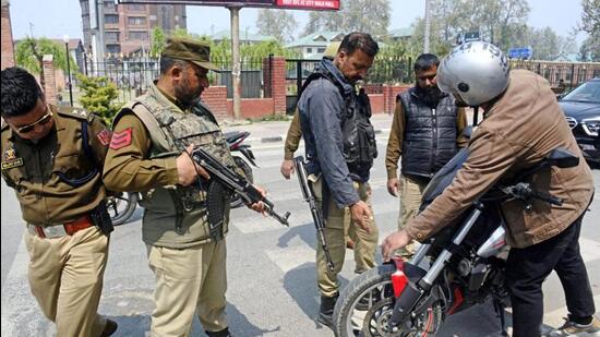 Personnel checking a two-wheeler after security was beefed up across Kashmir Valley in view of Union home minister Amit Shah’s visit in Srinagar on Monday. (PTI Photo)