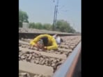 Reckless rail stunt in UP went viral as man lay under speeding train. He walked away unharmed but was soon arrested.
