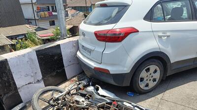 Trio flung off Mum-Goa flyover as speeding car hits their bike; 1 dead Trio flung off Mum-Goa flyover as speeding car hits their bike; 1 dead