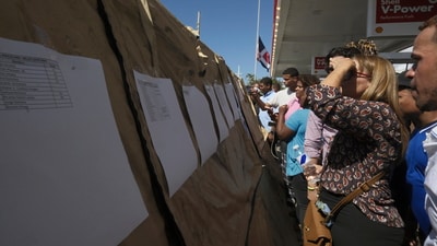 People read lists of survivors as crews search for others trapped at the Jet Set nightclub after its roof collapsed during a merengue concert in Santo Domingo, Dominican Republic, Tuesday, April 8, 2025. (AP Photo/Ricardo Hernandez) (AP) People read lists of survivors as crews search for others trapped at the Jet Set nightclub after its roof collapsed during a merengue concert in Santo Domingo, Dominican Republic, Tuesday, April 8, 2025. (AP Photo/Ricardo Hernandez) (AP)