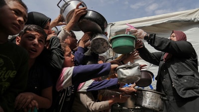 Palestinians wait to get donated food at a distribution center in Beit Lahiya in the northern Gaza Strip, Monday, April 7, 2025. (AP) Palestinians wait to get donated food at a distribution center in Beit Lahiya in the northern Gaza Strip, Monday, April 7, 2025. (AP)