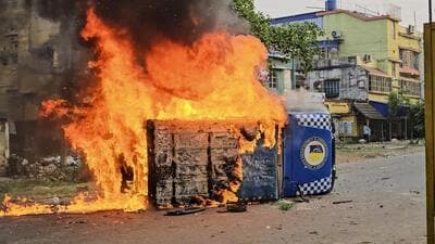 Smoke and flames billow out from a vehicle after it was set ablaze during a protest over the Waqf (Amendment) Act in Murshidabad district of West Bengal on Tuesday (PTI)