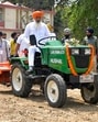 A farmer rides the new electric tractor in Ludhianaon Wednesday. (Manish/HT)