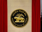 RBI Monetary Policy meeting: A worker walks past the logo of Reserve Bank of India (RBI) inside its office in New Delhi, India.