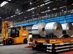 FILE PHOTO: A worker moves rolls of steel at the Tata Steel factory in Velsen-Noord, Netherlands March 26, 2024. REUTERS/Piroschka van de Wouw/File Photo