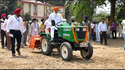 A farmer rides the new electric tractor in Ludhianaon Wednesday. (Manish/HT)
