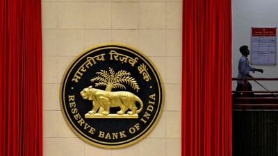 RBI Monetary Policy meeting: A worker walks past the logo of Reserve Bank of India (RBI) inside its office in New Delhi, India. (Reuters)